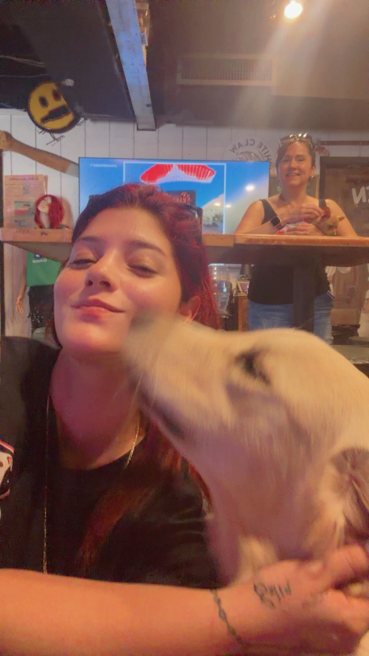 Kiara, owner of Pawcéa by Kiki, with a dog in her care
